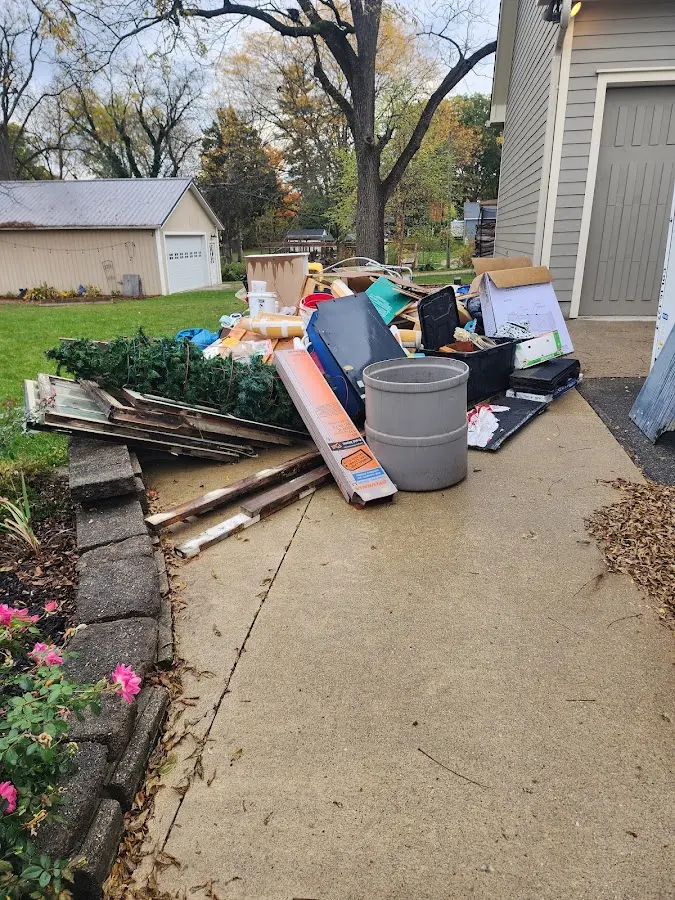 Dumpster being loaded with debris for Residential Dumpster Rental in Middleton